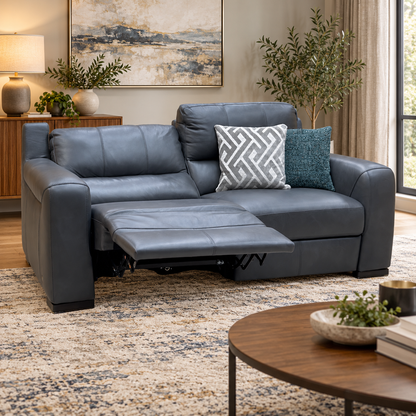 Marinelli Viali grey leather power recliner sofa reclined in a living room with a round wooden coffee table