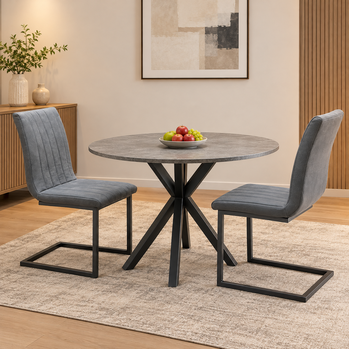 Pair of Moon grey fabric cantilever dining chairs either side of a round grey table in a dining room