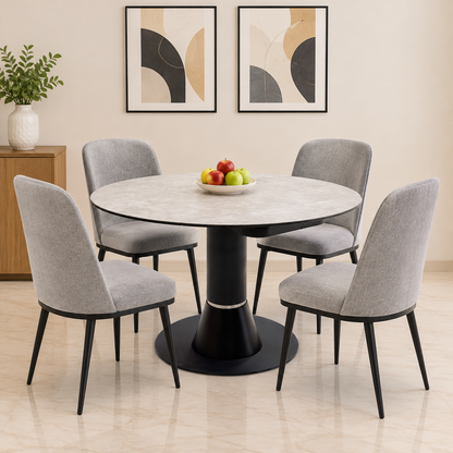 Enterprise grey ceramic top round dining table in a dining room with four grey fabric chairs and a fruit bowl