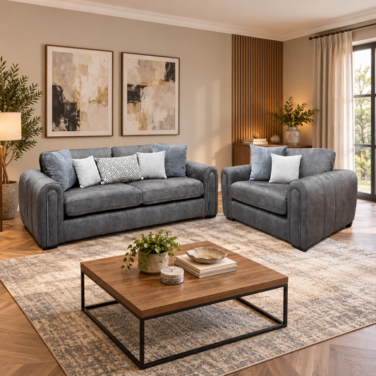 Amara charcoal grey velvet 3 seater sofa and snuggle chair in a living room with abstract prints and a walnut coffee table