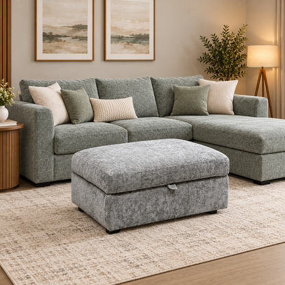 Pandora Denby silver fabric large storage footstool in front of a grey corner sofa in a living room