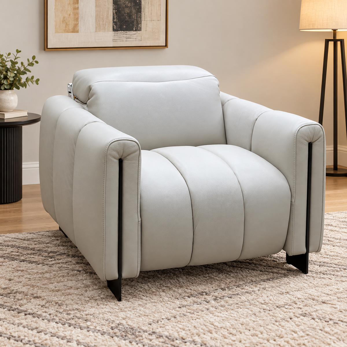 Giorgio light grey leather armchair on a cream rug in a living room with a floor lamp