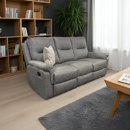 Gray sofa in a living room with wooden bookshelf and coffee table