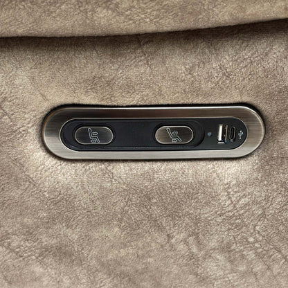 Close up view of the Sloane armchair in Charcoal Grey, showcasing the plush padded armrests and the rich, shimmering texture of the velvet upholstery.