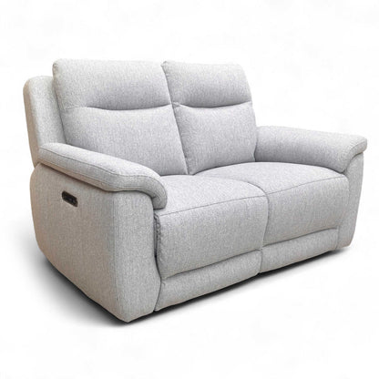 High-angle perspective view showing the deep seating and contemporary silhouette of the stone grey sofa.