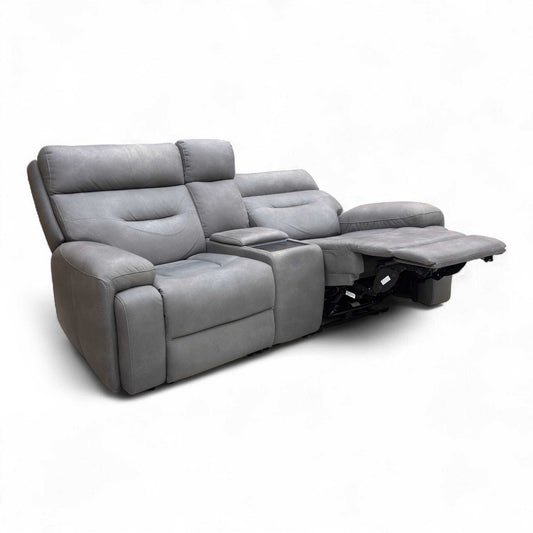 Full view of furniture Village 'Cinemax' 2-seater power recliner sofa in Nappa Grey velvet with a central media console.