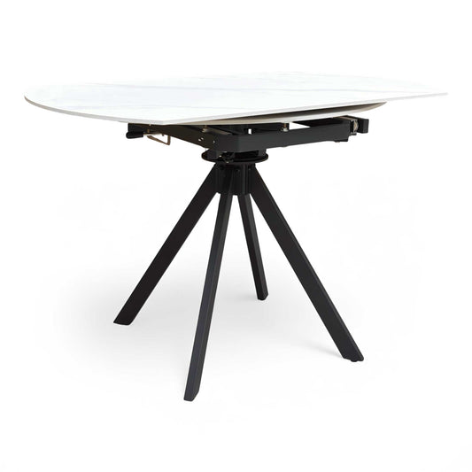 Full view of the Robert dining table with the swivel extension mechanism partially engaged, showing the clever space-saving design.