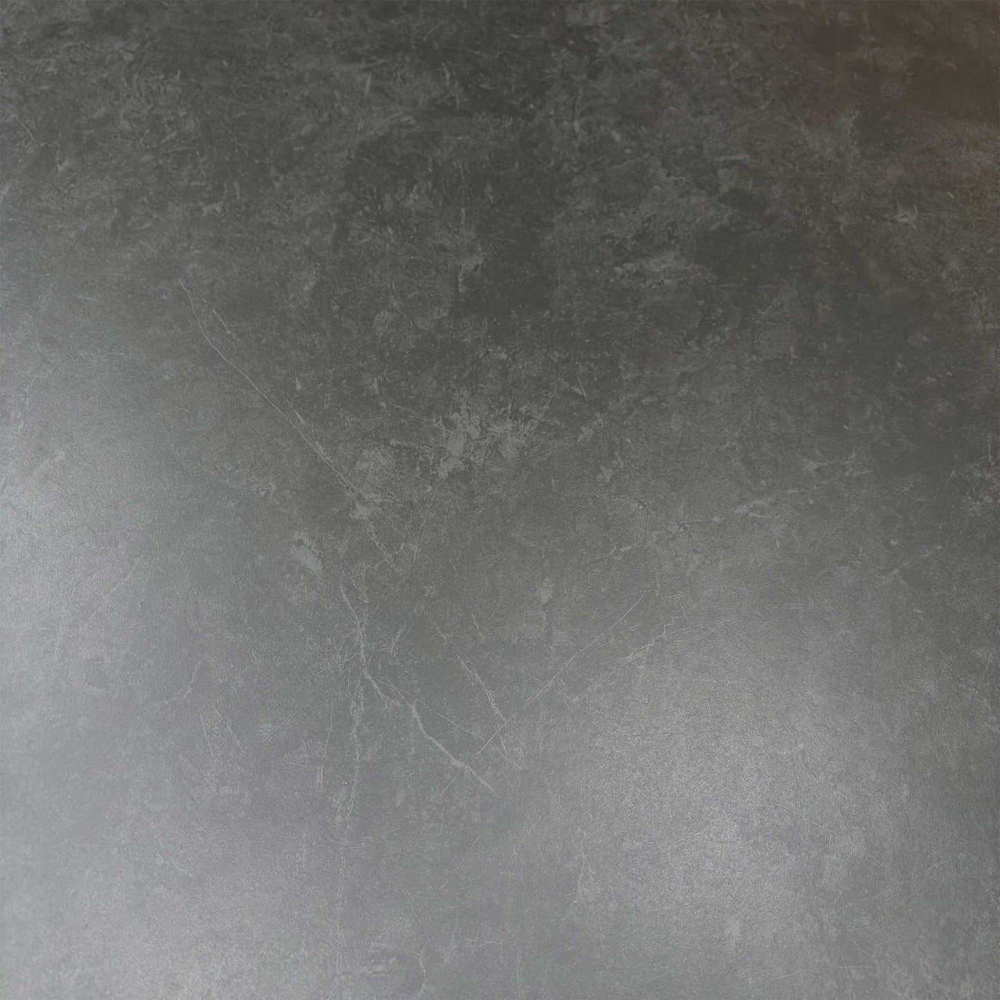 Close-up of the durable grey sintered stone tabletop surface with scratch-resistant industrial detail.