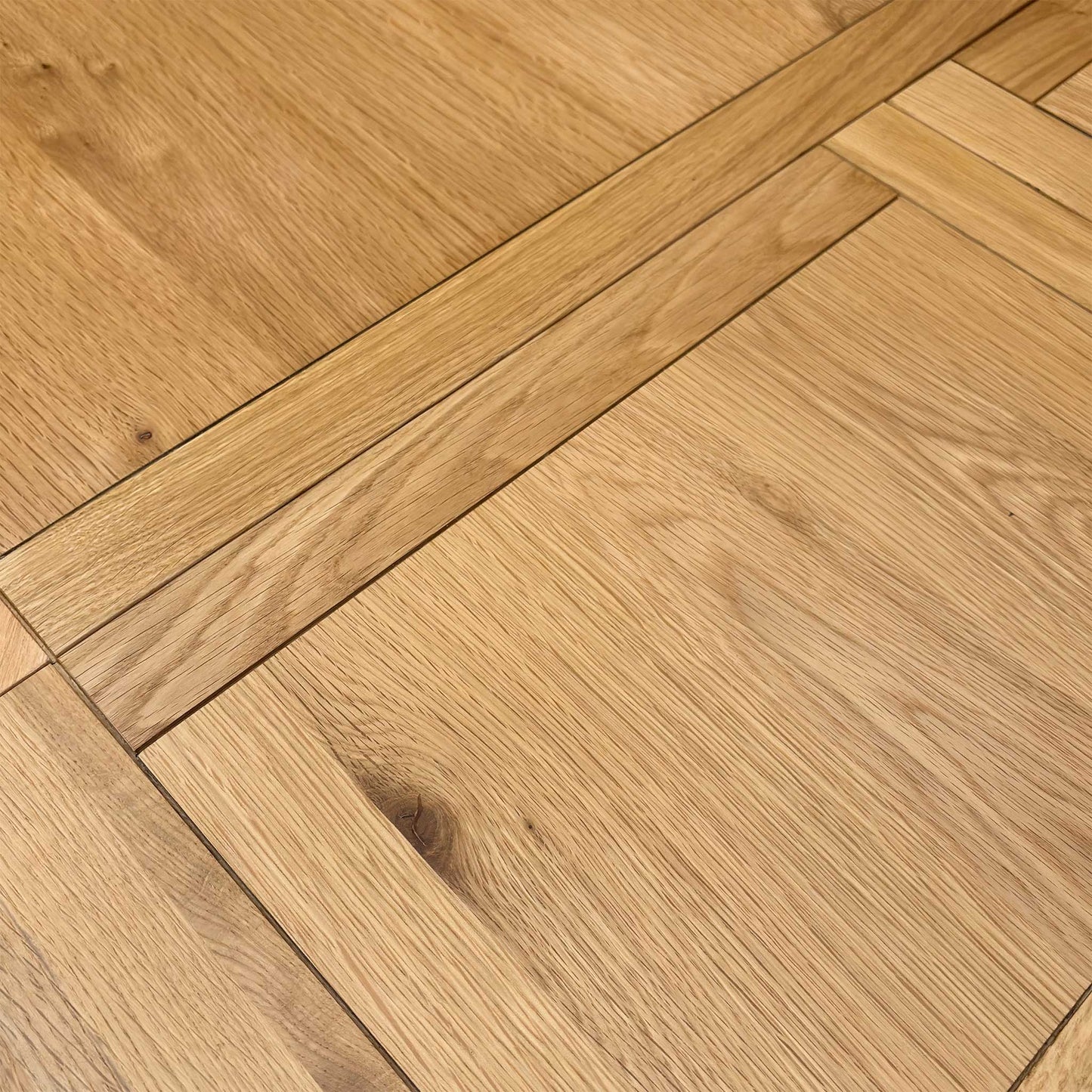 Macro view of the Augusta dining table surface, highlighting the high-quality rustic wood grain texture, durable protective finish, and natural timber tones.