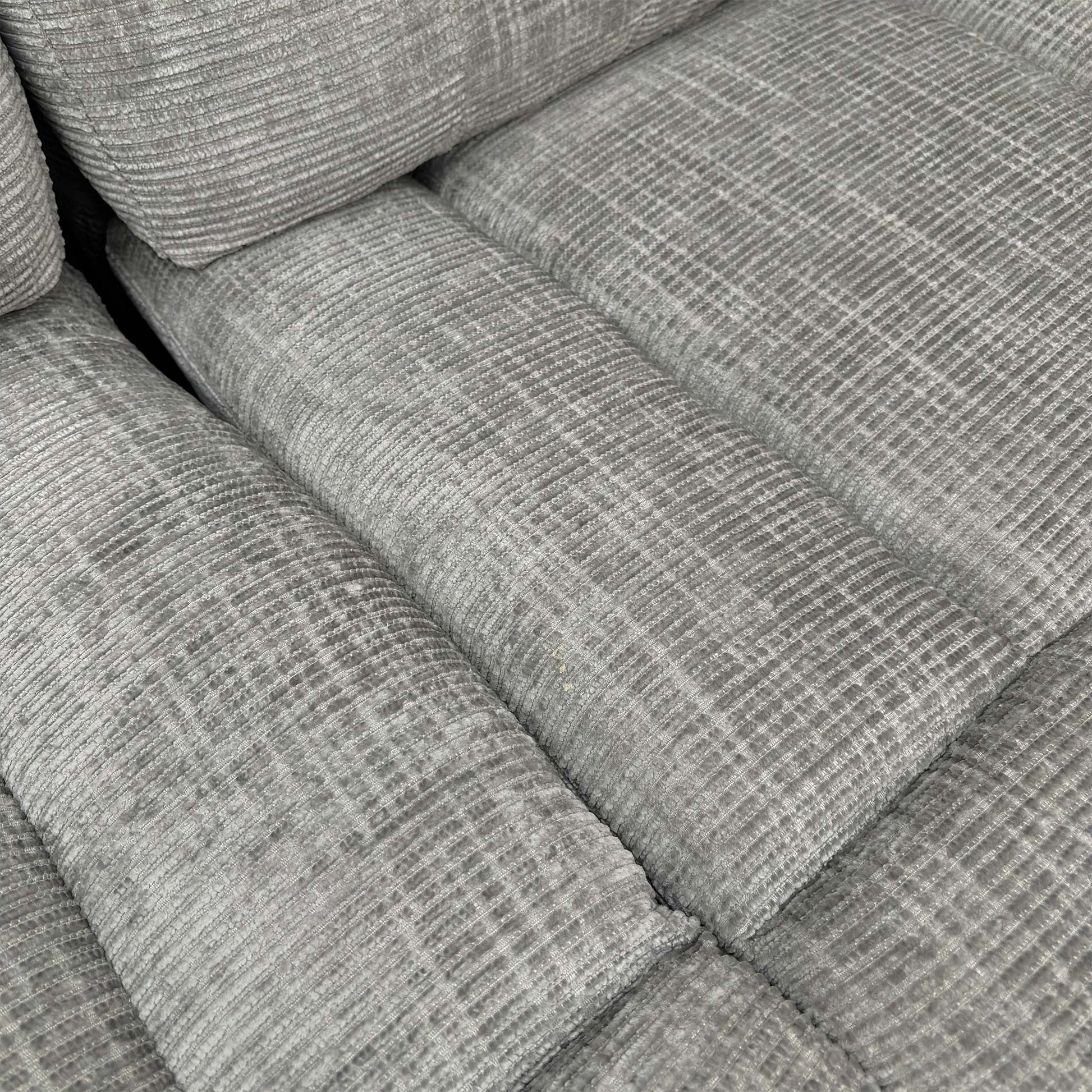 Close-up of the seating area on the ‘Wilbur’ sofa, detailing the grey fabric texture and durable stitching.