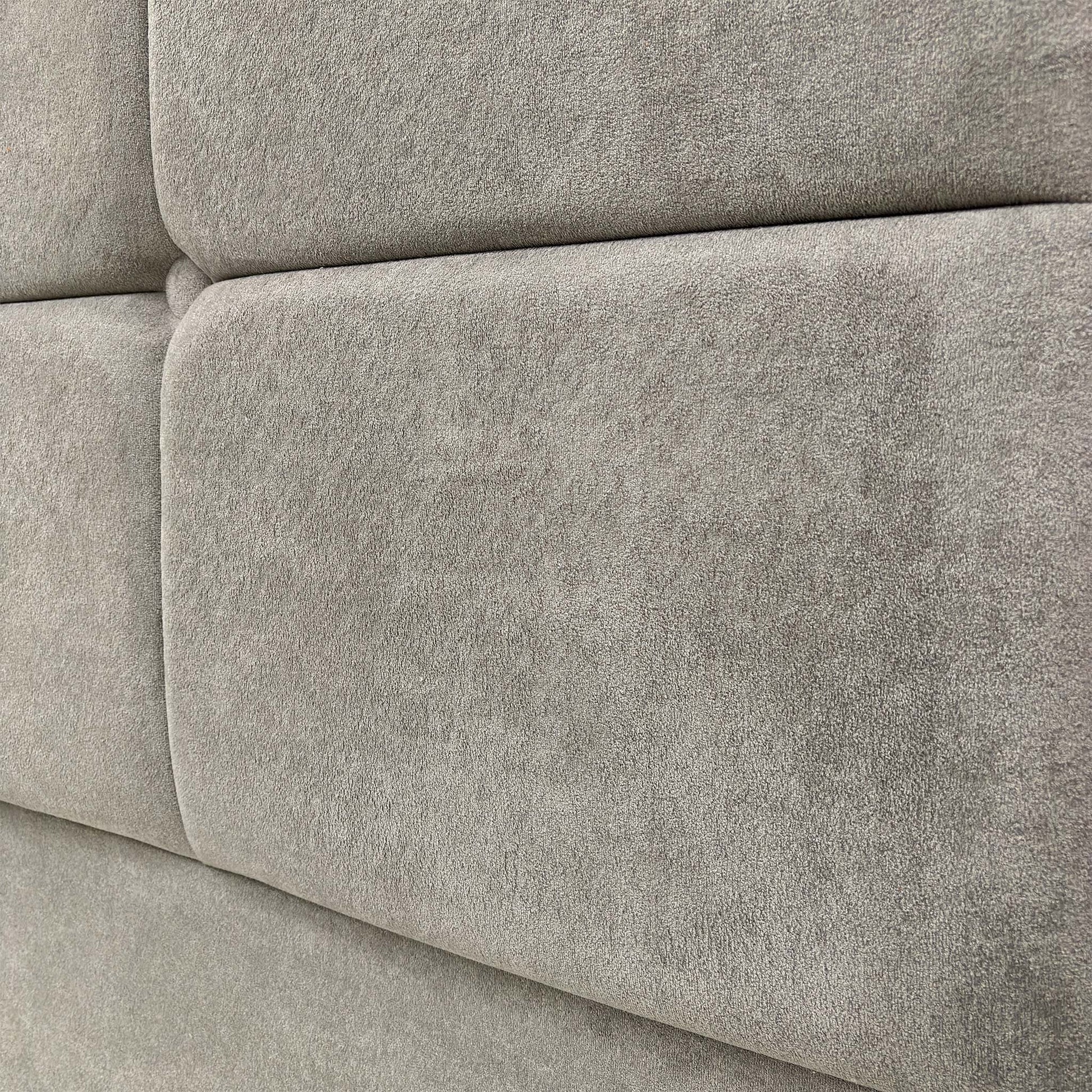 Close-up of the Milan floor-standing headboard, showing the sophisticated nickel fabric texture and high-quality craftsmanship.