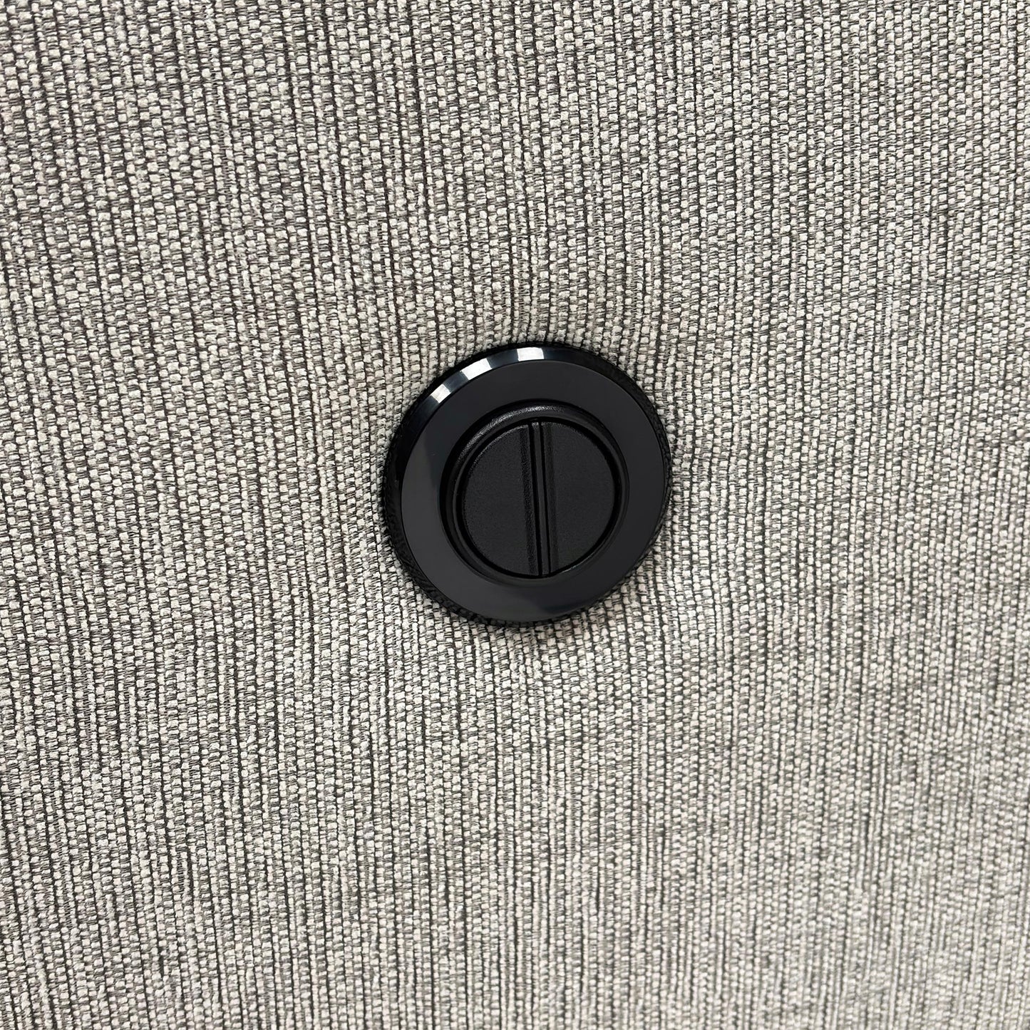 Close-up of the Bariba Grey woven fabric and chrome insert, highlighting the premium textured finish and high-quality craftsmanship of the upholstery.