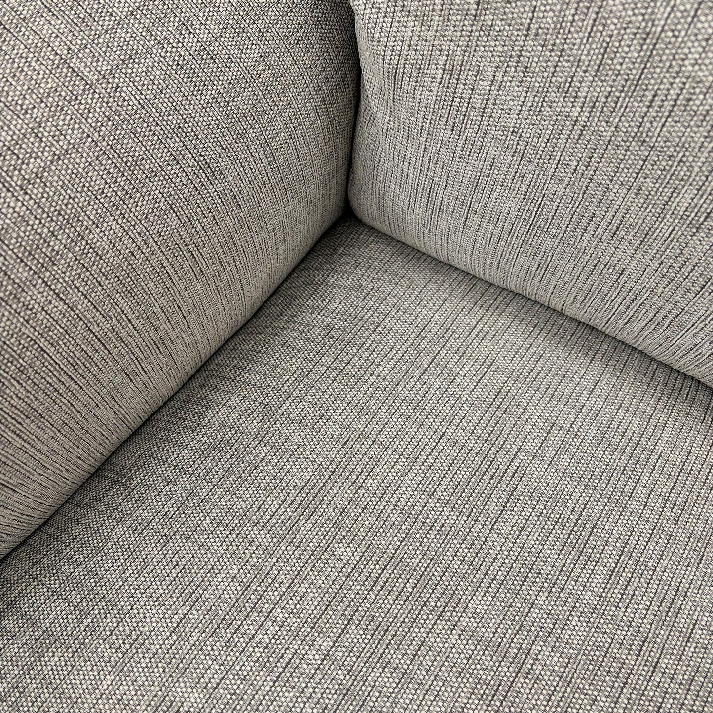 Close-up of the Bariba Grey woven fabric and chrome insert, highlighting the premium textured finish and high-quality craftsmanship of the upholstery.