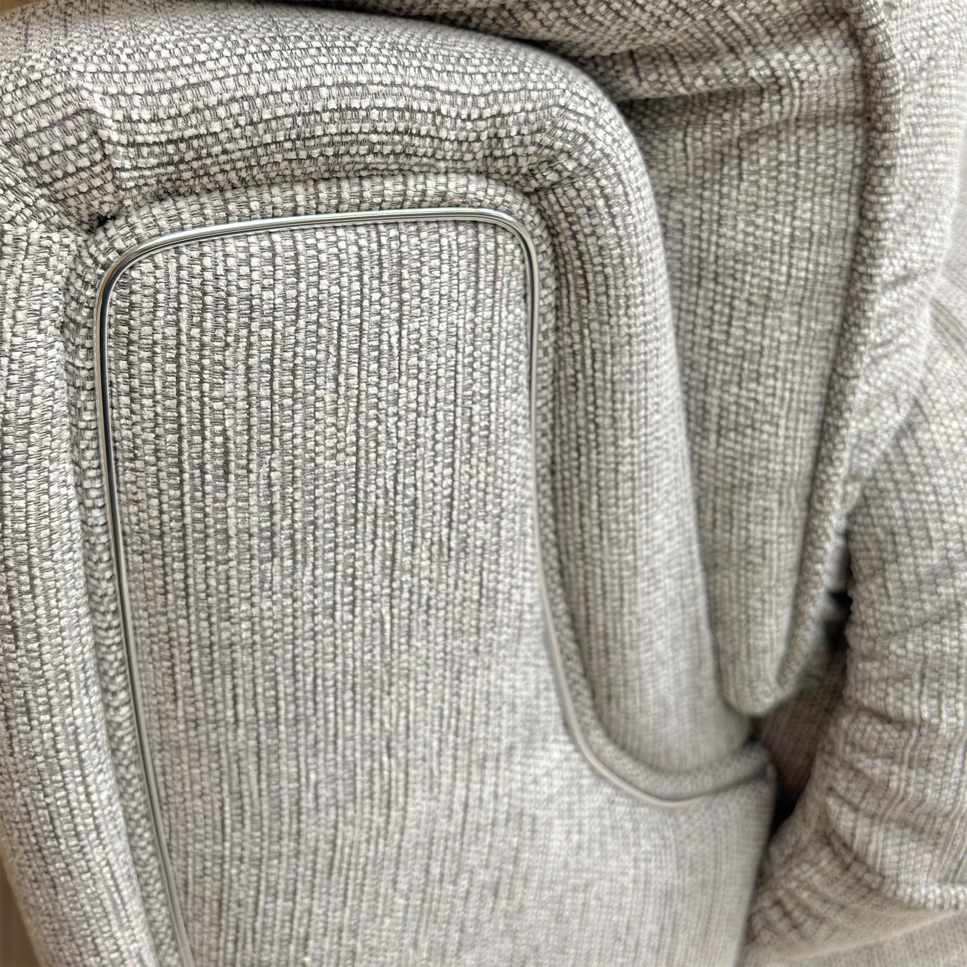 Close-up of the Bariba Grey woven fabric and chrome insert, highlighting the premium textured finish and high-quality craftsmanship of the upholstery.