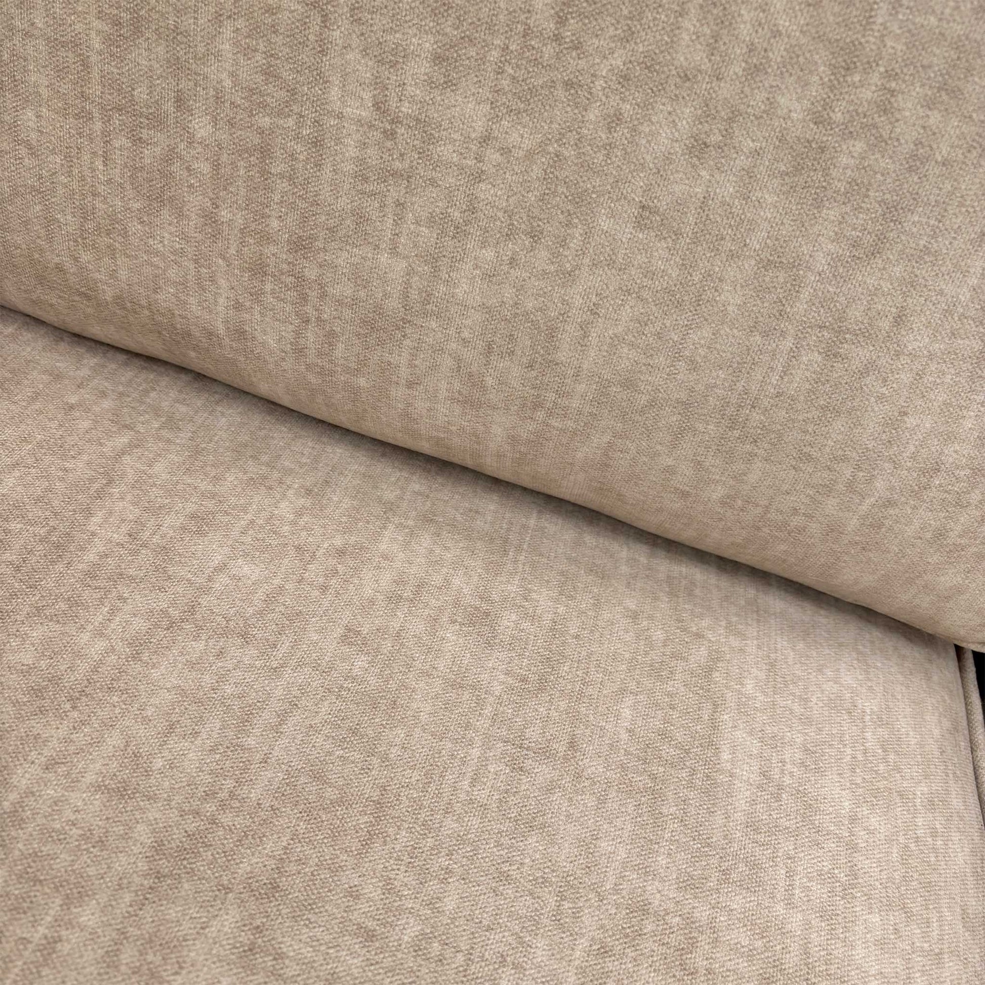 Close-up of the luxurious beige Vogue velvet fabric and detailed stitching on the Chelsea sofa frame.