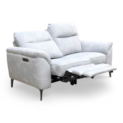 The Furniture Village ‘Morgan’ Dexter Smoke 2-seater power recliner sofa, featuring a modern mid-century design with velvet upholstery and tapered metallic legs.