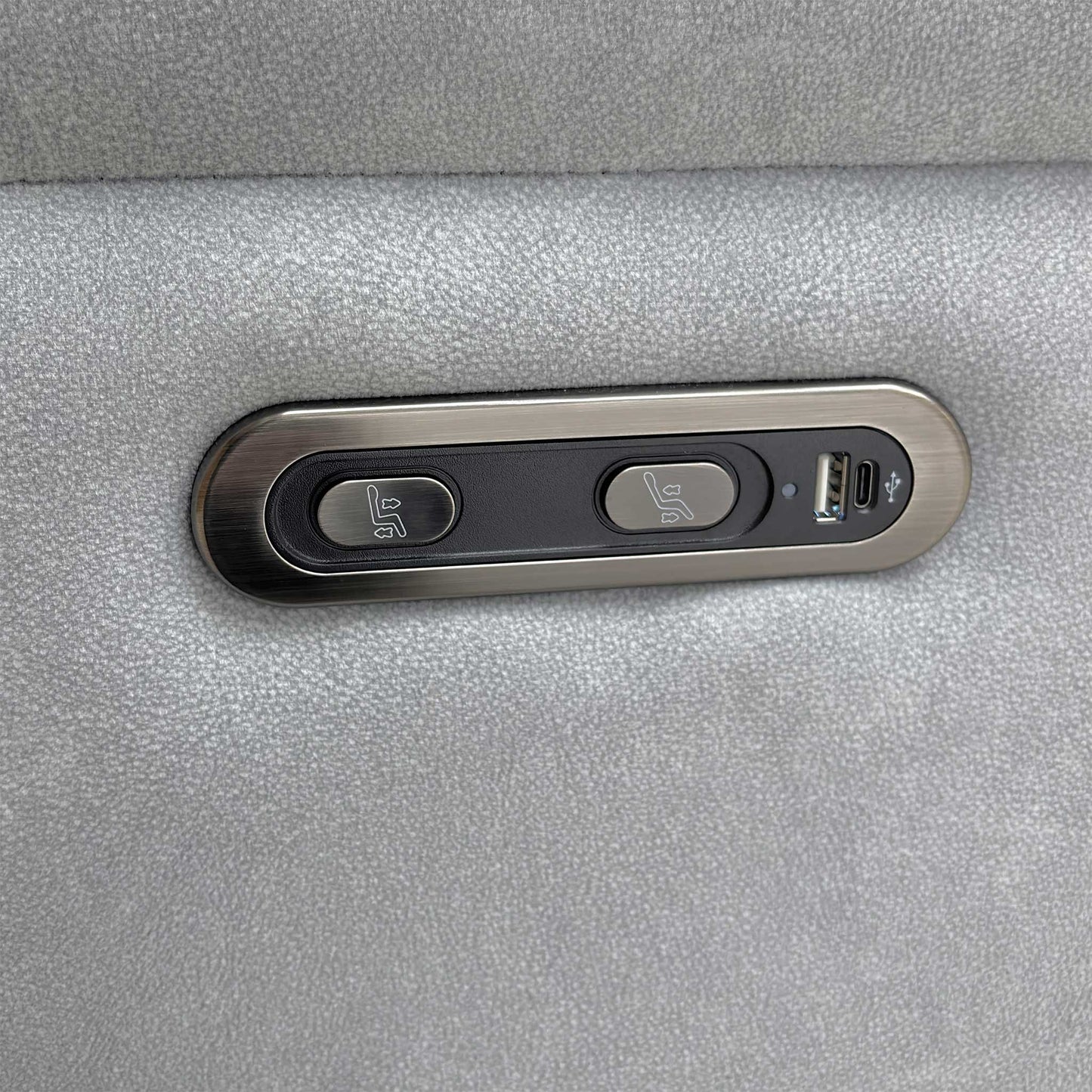 Close-up of the integrated power recliner controls and USB charging port, designed for convenient device charging while relaxing.