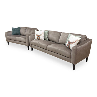 Side view of the Oslo Vogue velvet sofa frame, illustrating the generous seating depth, angled backrest support, and sturdy modern base feet.
