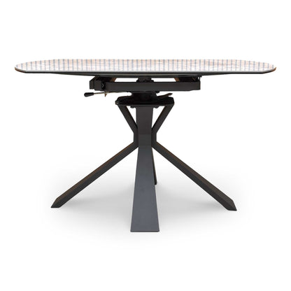 Front view of the Crete white ceramic dining table fully extended, comfortably styled with modern velvet swivel dining chairs.