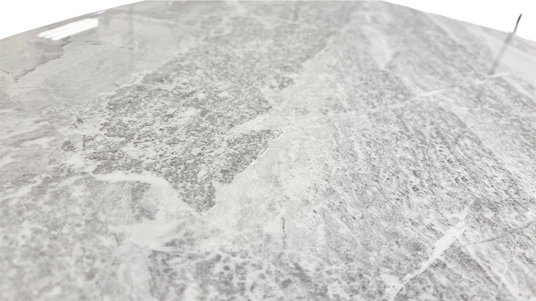 Detailed close-up of the real marble tabletop, showing the natural grey veining and smooth, polished surface.