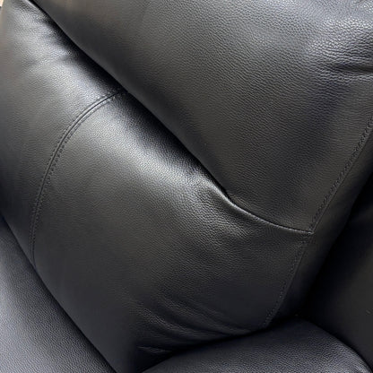 Detail shot focusing on the leather material, stitching, and high-back headrest.