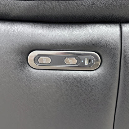 Close-up showing the controls for the power recliner mechanism, including the USB charging port located on the armrest.