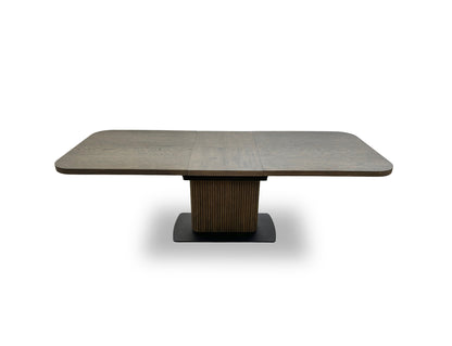 Close-up of the dark oak veneer tabletop, highlighting the wood grain texture and rounded corner detail.