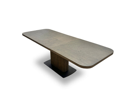 View of the butterfly extension leaf partially or fully visible in the center of the dark oak tabletop.