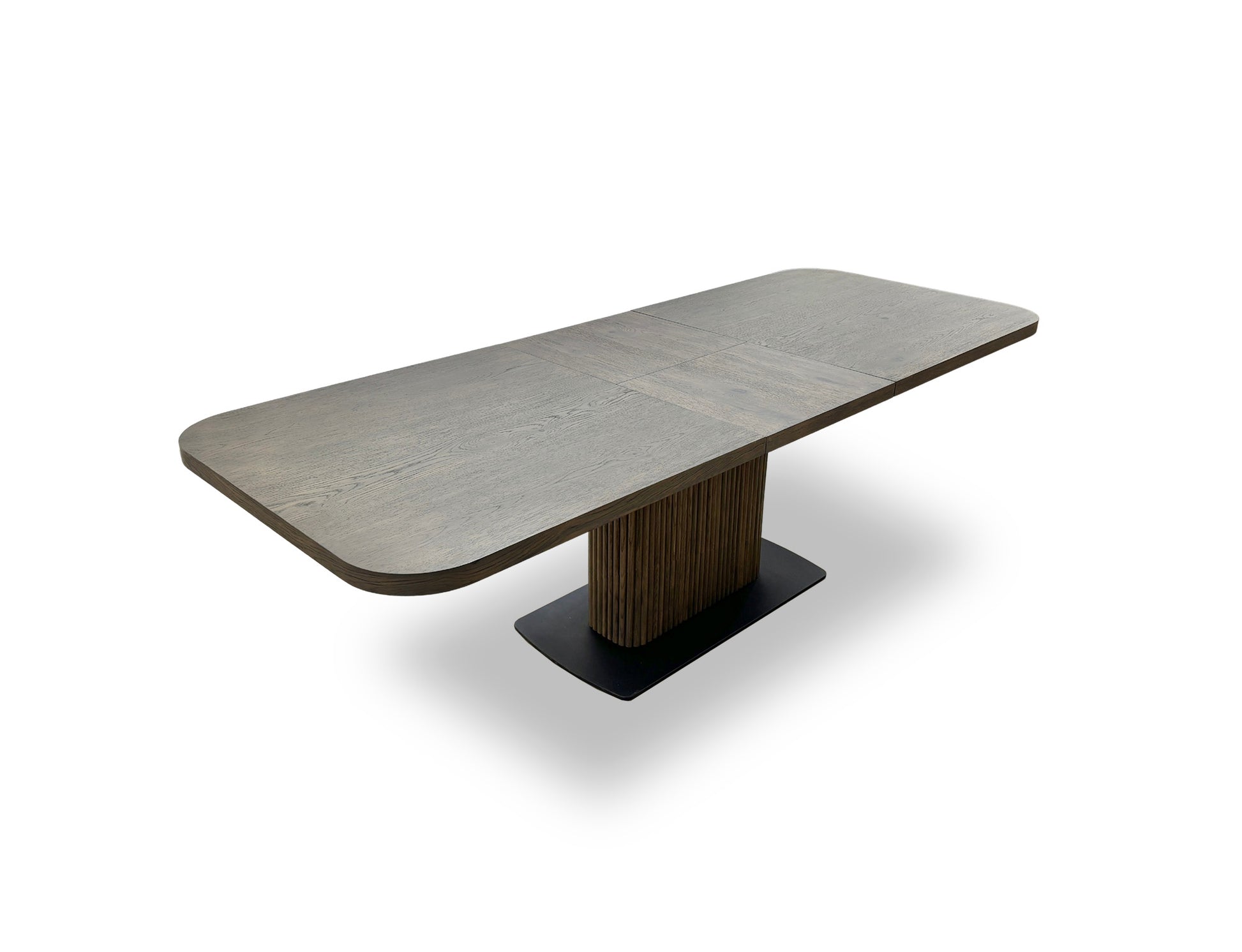 Angled detail shot of the oak pedestal base, showing its texture, grooves, and the supporting black metal plinth.