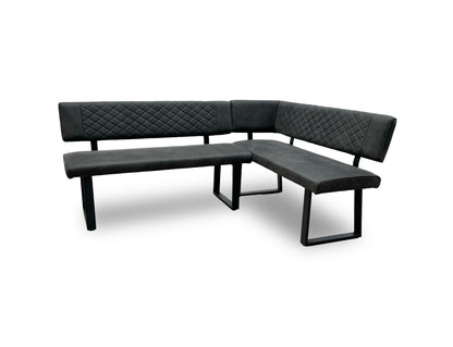 Angled view of the ‘Warrior’ dining bench showing the industrial-style black U-shaped metal legs.