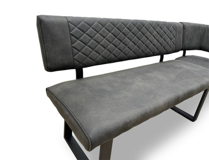 Close-up of the grey fabric upholstery on the ‘Warrior’ bench, emphasizing the quilted-effect stitching.