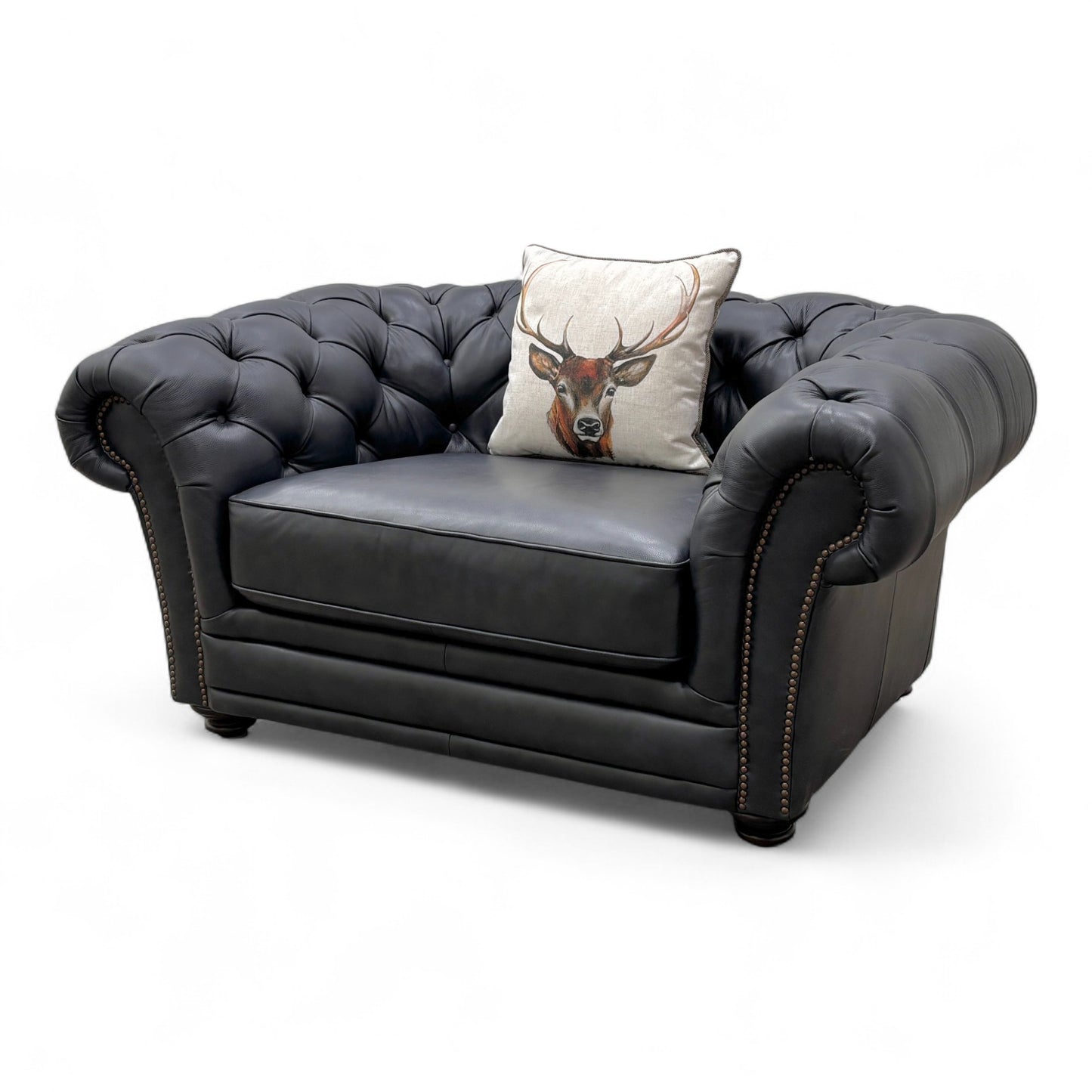 Side view of the 'Savannah' navy blue leather snuggler chair, showcasing the curved armrests and overall cozy 'cuddler' size.