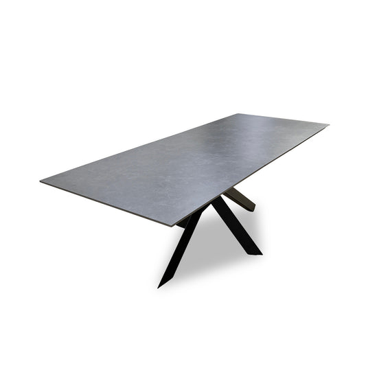 Full view of Furniture Village 'Warrior' extending dining table with a durable grey sintered stone top.