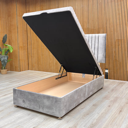 Detail view of the end-lift ottoman base in its open position, demonstrating the vast under-bed storage space for linens and essentials.