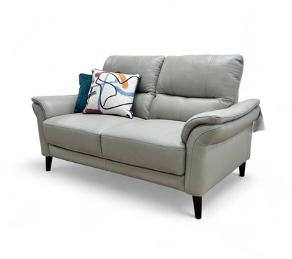 Side profile view of the 'Winner' Oslo 2 Seater Sofa, clearly showing the shape of the rolled arm and the tapered wood legs.