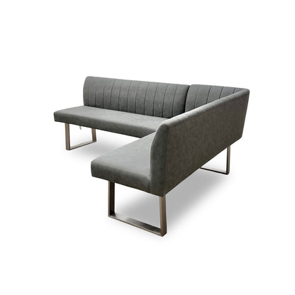 View of the 'Grigio' Right-Hand Facing Corner Dining Bench showcasing its modern design with brushed stainless steel U-shaped legs.