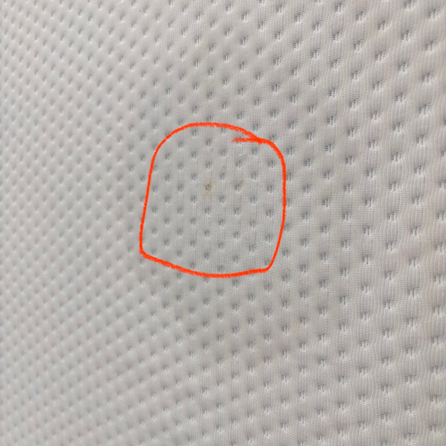Emma Mattress Original Super King - close-up of white cover fabric with a small mark circled to highlight material detail