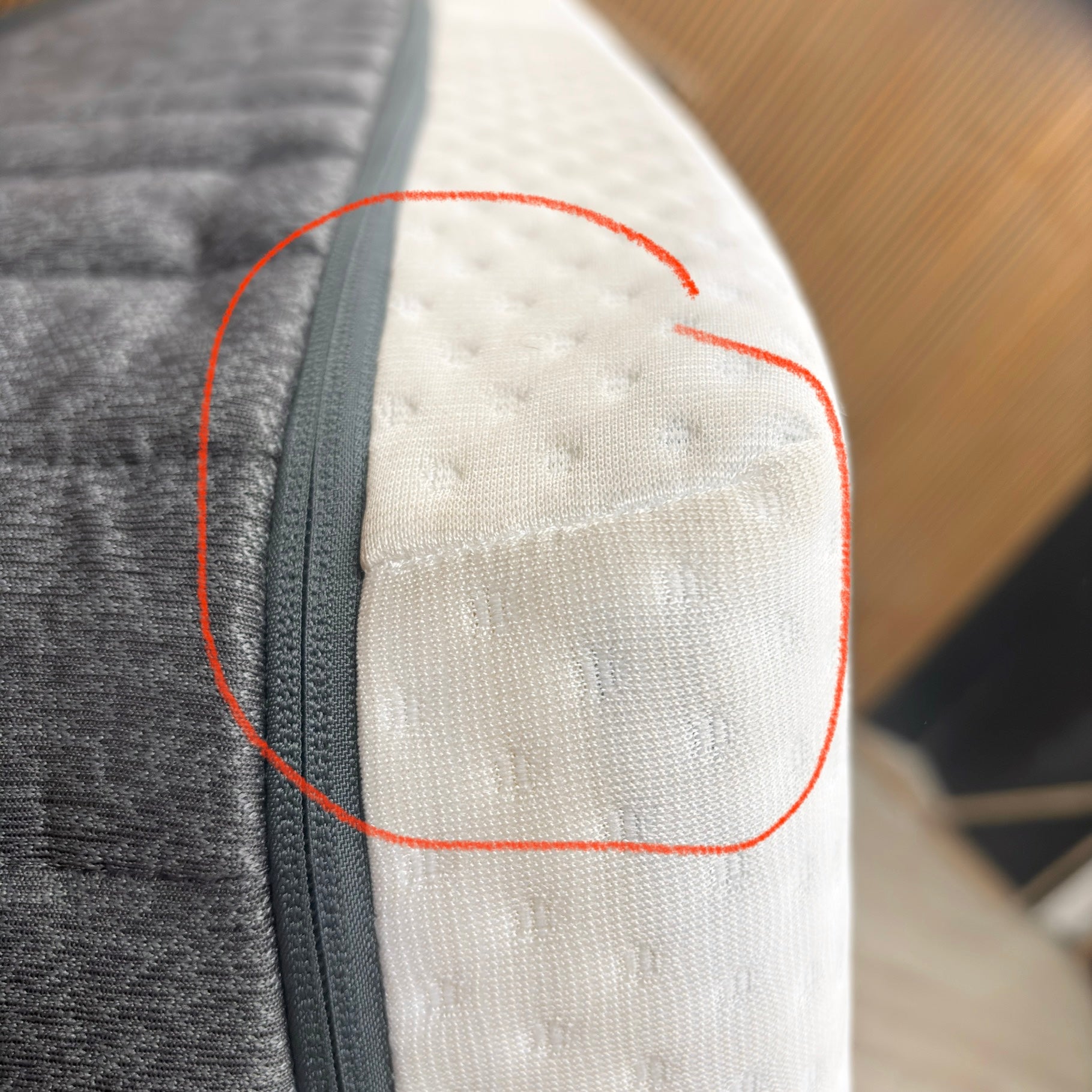 Emma Mattress Original Super King - close-up corner view showing white quilted top and grey side panel with circled detail area