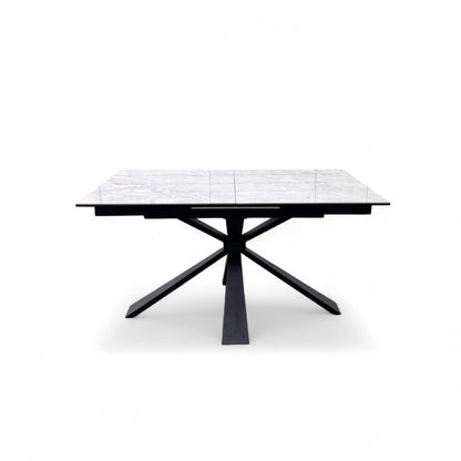 Side View of the sculptural black metal pedestal base that supports the ceramic top of the Crete dining table.