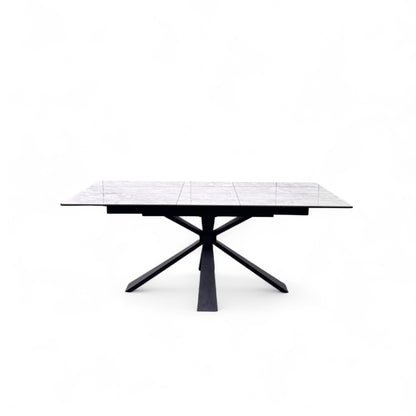 Front view of the Crete dining table extended to its full 180cm length, highlighting the smooth transition of the white ceramic top.
