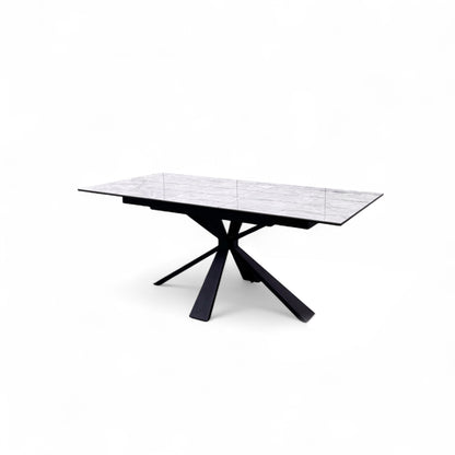 Angled shot of the Crete dining table, emphasizing the unique modern design of the black powder-coated metal base.