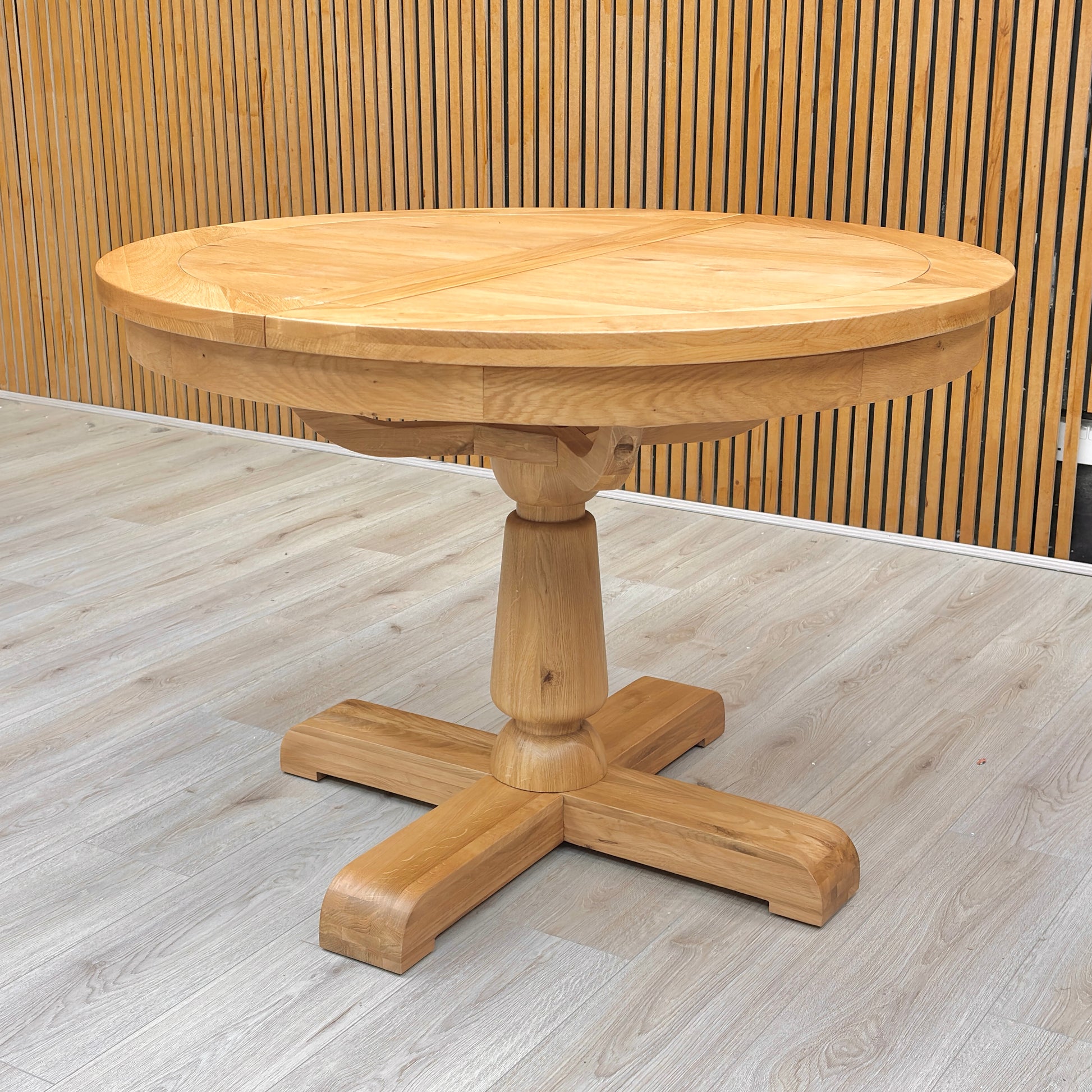 Lifestyle view of the Augusta dining table's central pedestal leg structure, showcasing the craftsmanship, stability, and elegant turned wood design.