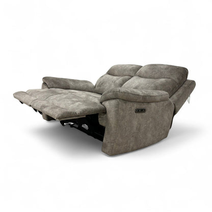 The Charcoal Grey Velvet Sloane Sofa with the power recliner footrest fully extended, showing the comfortable lounging position.