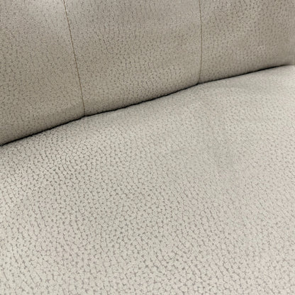 Close-up view of the button-tufting detail on the high back of the 'Mia' silver suede dining chair.