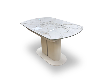 Side profile view of the table, emphasizing the sleek, slim profile of the ceramic-on-glass tabletop and the architectural curves of the central fluted pedestal.