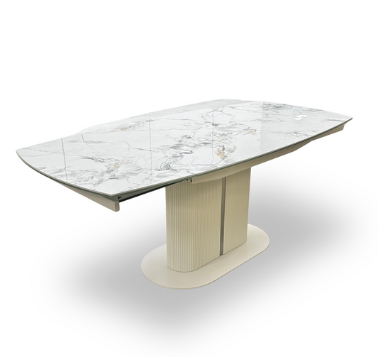 Full view of the Avorio swivel extending dining table, showcasing its glossy white marble-effect ceramic top and a modern pedestal base with a fluted texture.