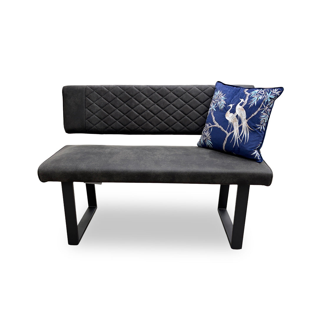 Full, angled view of the 'Warrior' high-back dining bench, featuring charcoal grey quilted-effect upholstery and modern U-shaped metal legs.