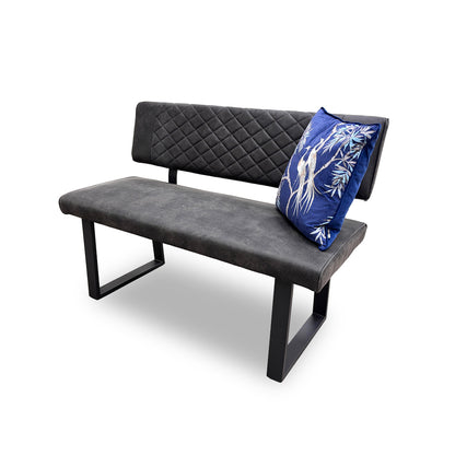 Side view of the 'Warrior' dining bench, highlighting the depth of the seat and the sleek, U-shaped metal legs.