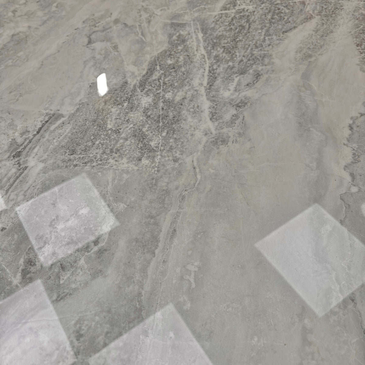 Close-up of the genuine marble tabletop highlighting the natural grey and white veining.