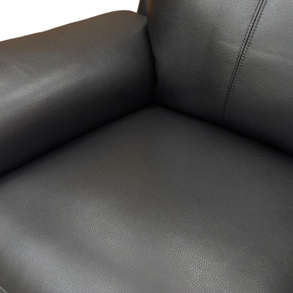 Detailed shot of the leather grain and stitching on the 'Bobby' black leather recliner set.